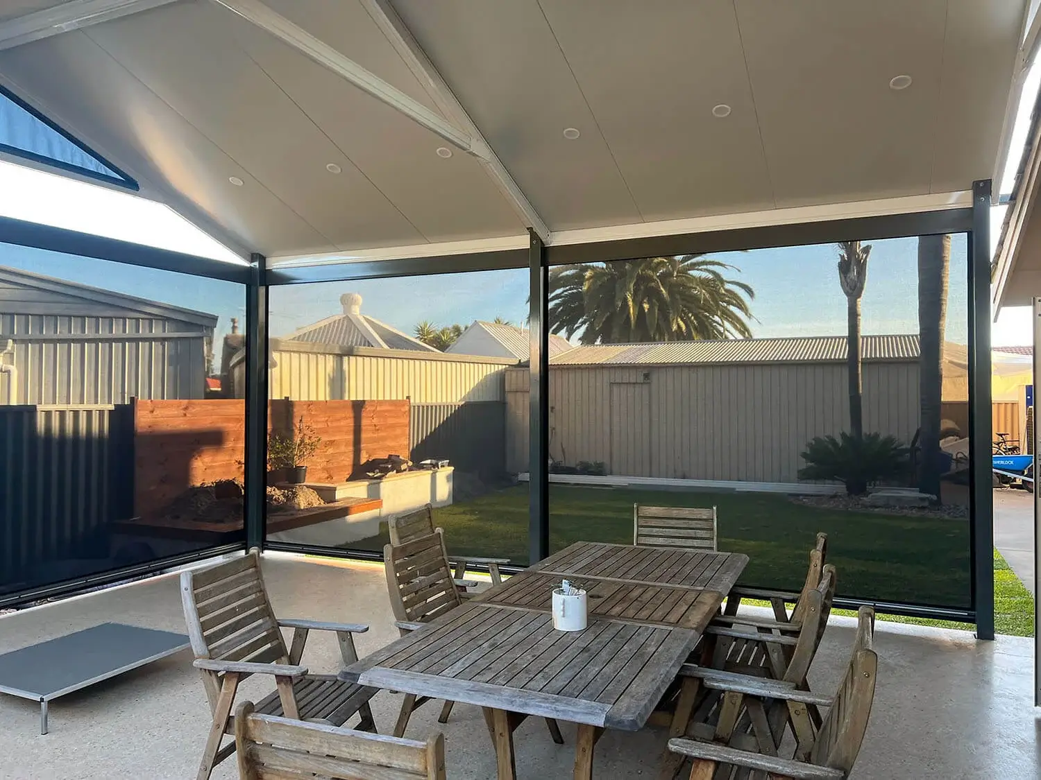 Outdoor blinds installed on a patio to reduce heat and provide shade.