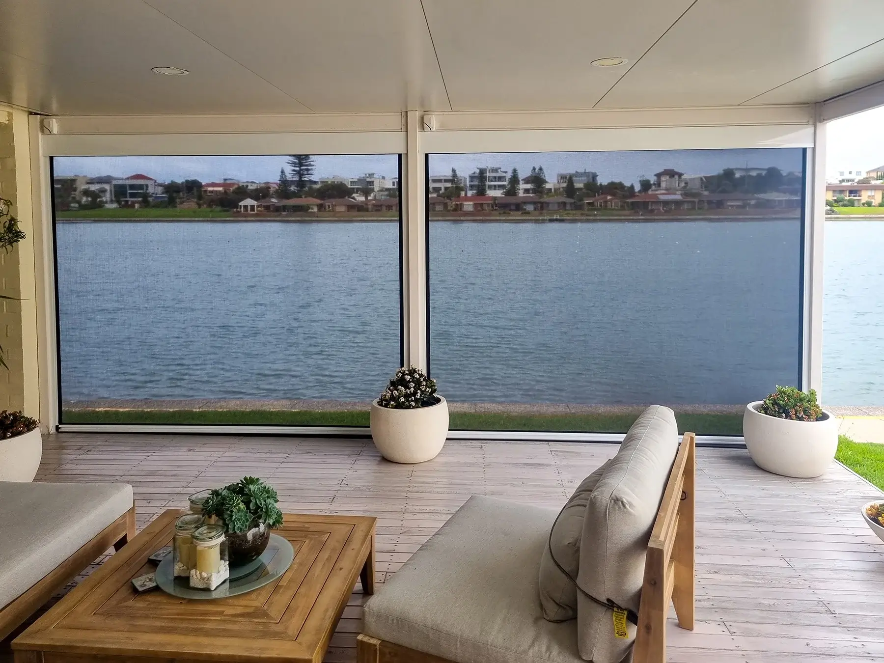 Two Outdoor Blinds attached to a patio, overlooking the ocean
